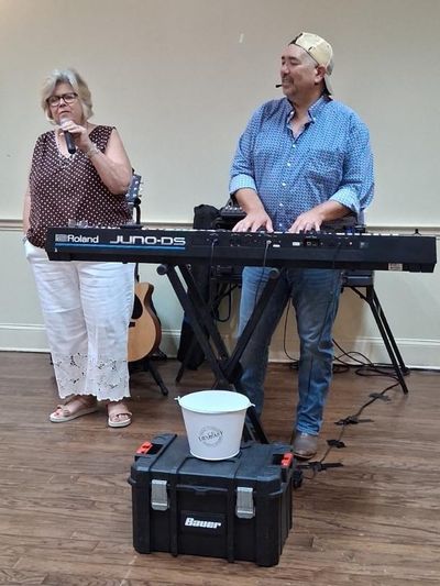 Cathy Taylor singing with the performer of the evening, Mike English.