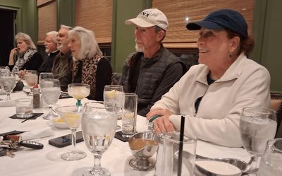 Cindy Moore and others visiting before dinner is served.