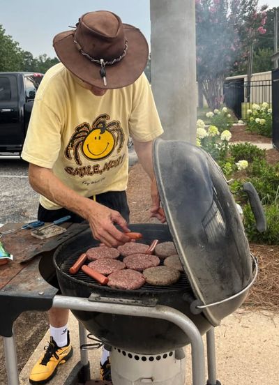 Mark Campbell preparing the burgers and hot dogs