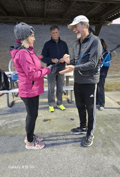 Melanie Little and Brad Moore determining who will win serve.