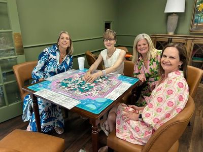 Stephanie Hawkins, Sabrie Graves, Renee Molette and Missy Thomas playing Mahjong after the fashion show.