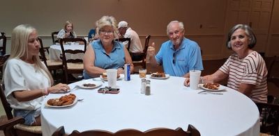 Cathy Taylor (second from left) enjoys the Post Tournament Party with family and friends.