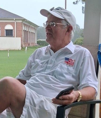 Terry Honan waits out the rain delay.  Terry and his wife Claire are responsible for bringing Croquet to ECC.  Croquet Club members continue to appreciate their efforts on our behalf.